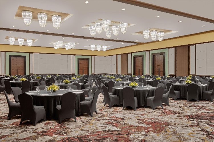 Ballroom set for a banquet with round tables and crystal chandeliers
